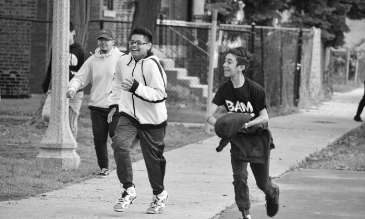 Kids from the Becoming a Man (BAM) project running and playing