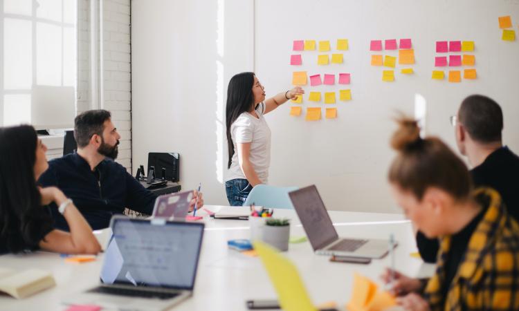 People working around a table and whiteboard