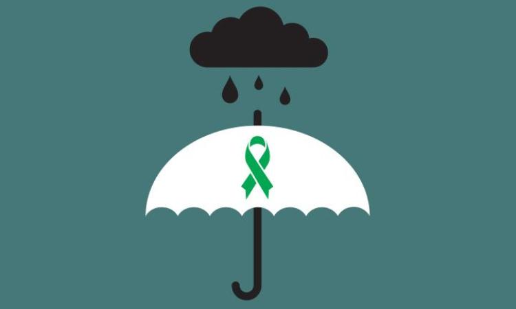 Graphic of an umbrella in the rain, with the Mental Health Foundation green ribbon symbol