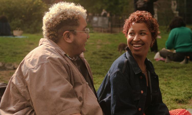 A trans couple at a picnic in the park