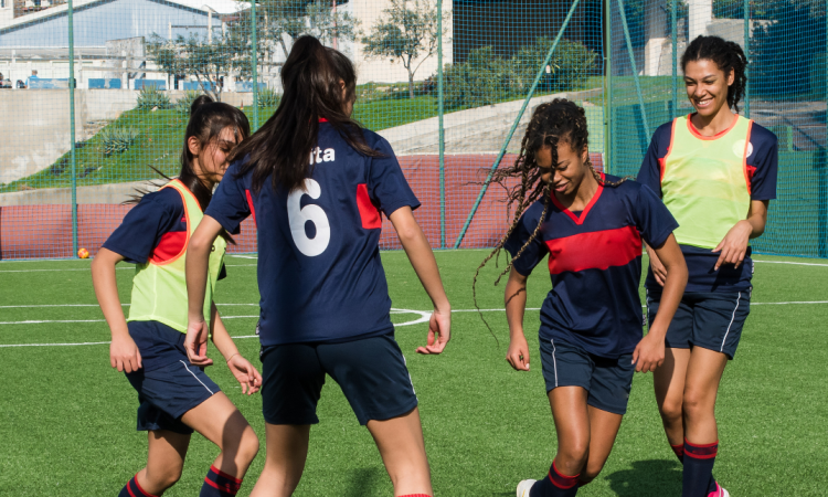 Group of teenagers playing football