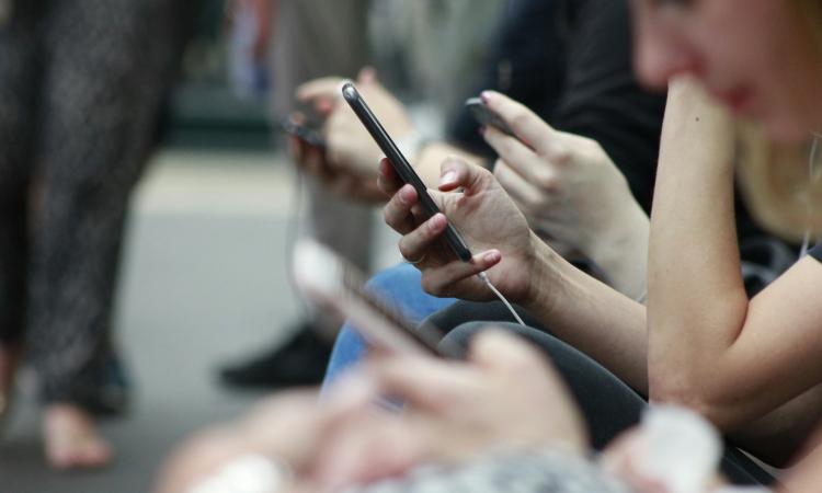 Lots of people using mobile phones