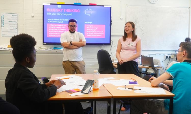 Two trainers presenting to a classroom of students during a UOK? workshop